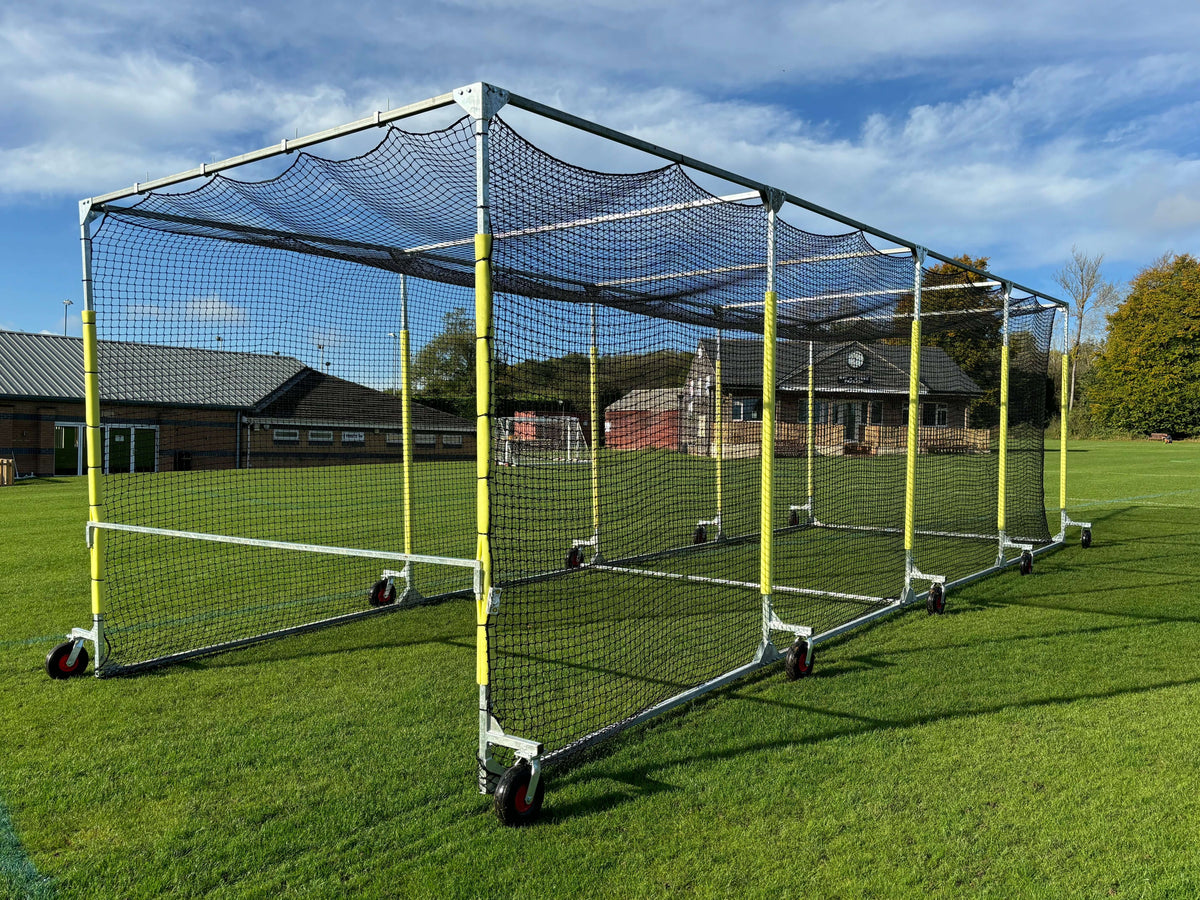 11m Anti-Vermin Mobile Batting Cage placed on a grass field with a clear sky.