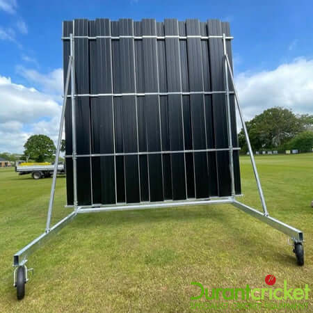 4.5M High X 4M Wide Black And White Swivel Sight Screen on a grassy field under a blue sky.