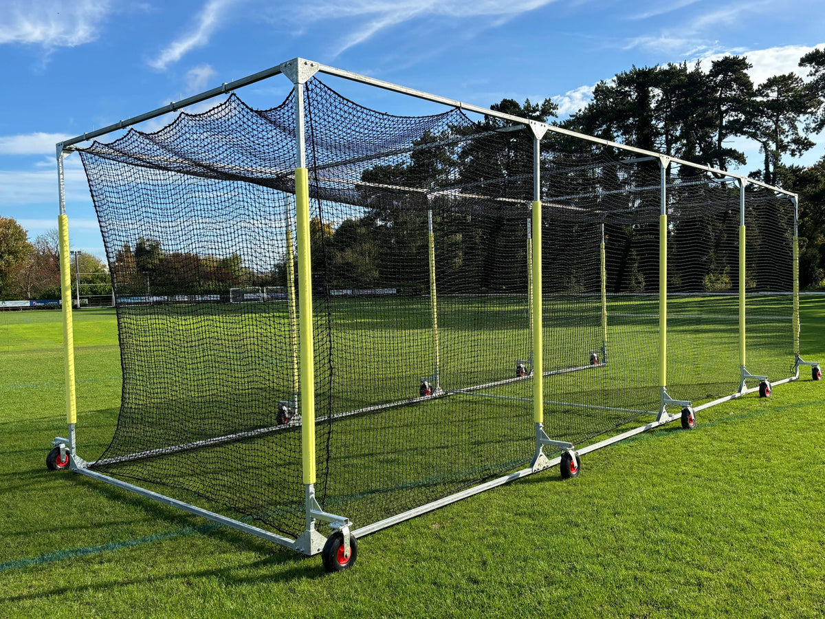 11m Anti-Vermin Mobile Batting Cage on a grassy field with clear blue sky in the background.