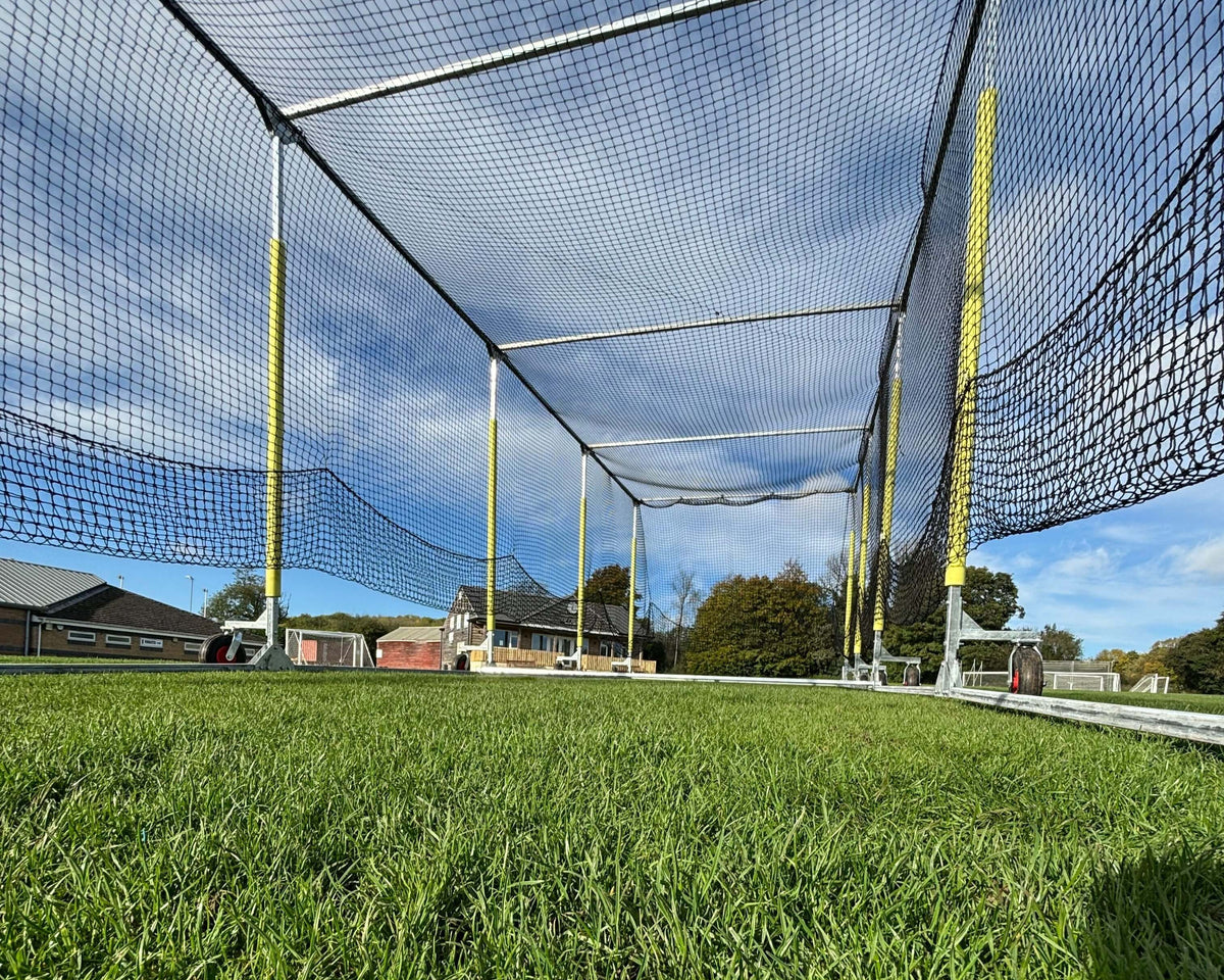 11m Anti-Vermin Mobile Batting Cage view from inside with net and support poles on green grass.