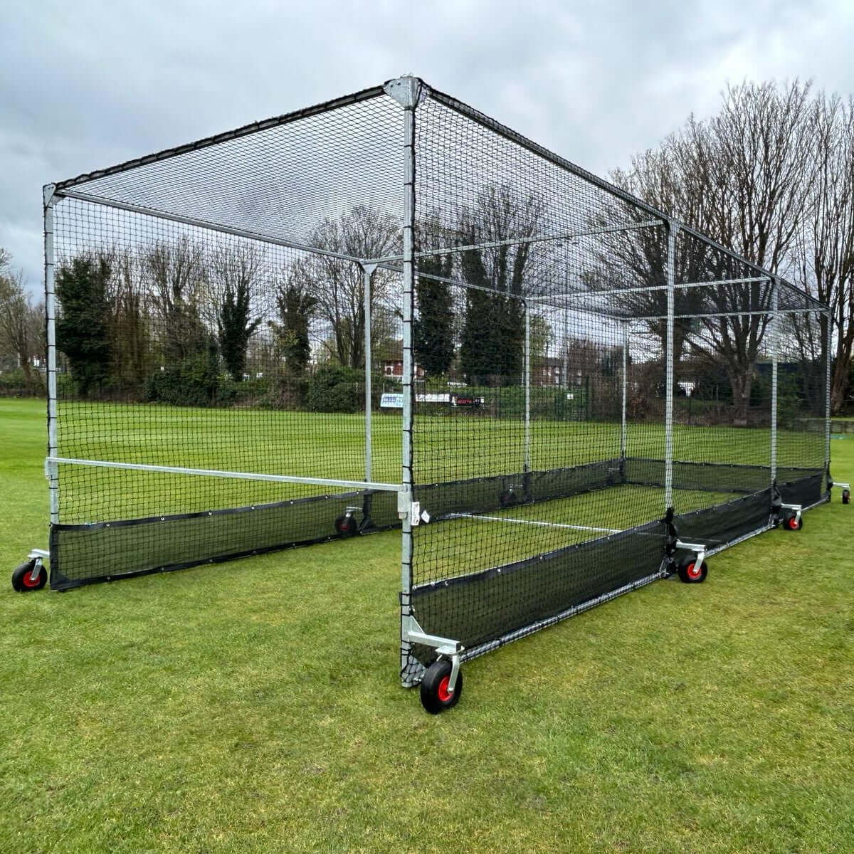 50m x 500mm Anti Vermin Skirt attached to mobile cage structure in a grassy field.