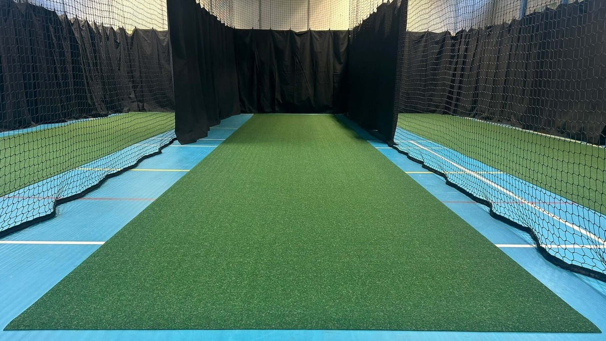 Durant Cricket Roll-Down surface within a cricket training facility, featuring a vibrant green surface and safety nets.